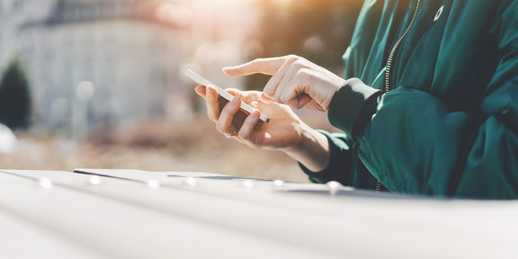 Person tippt etwas auf einem Smartphone ein